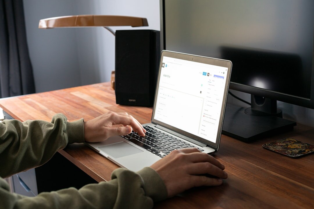 Person typing on laptop with media publishing dashboard