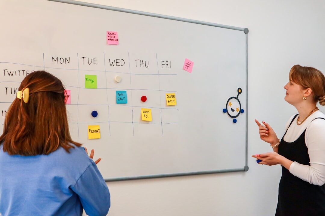 Media professionals discussing strategy around a whiteboard